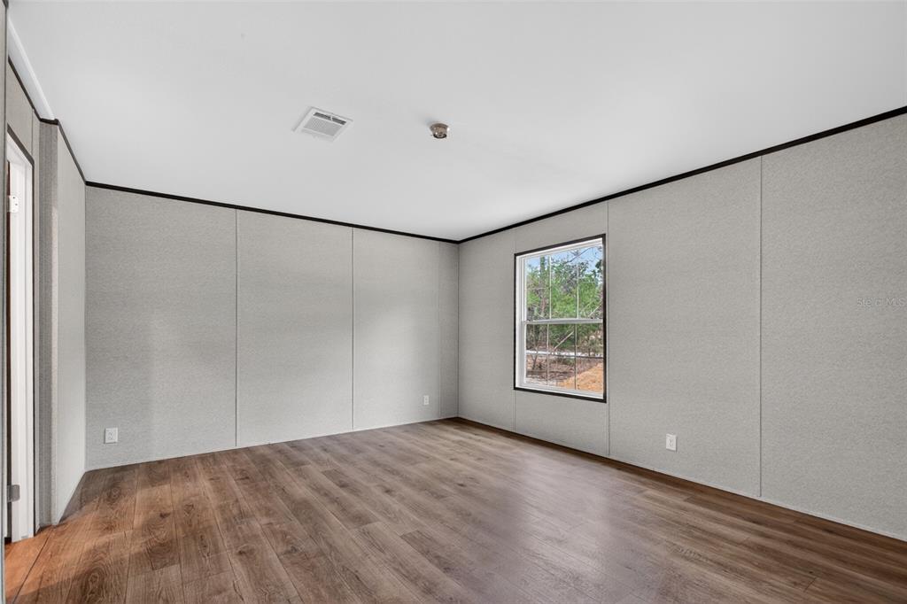 419 Lily Trail Interlachen, FL 32148 - Photo 12 of 82 a view of an empty room with a window and a ceiling fan