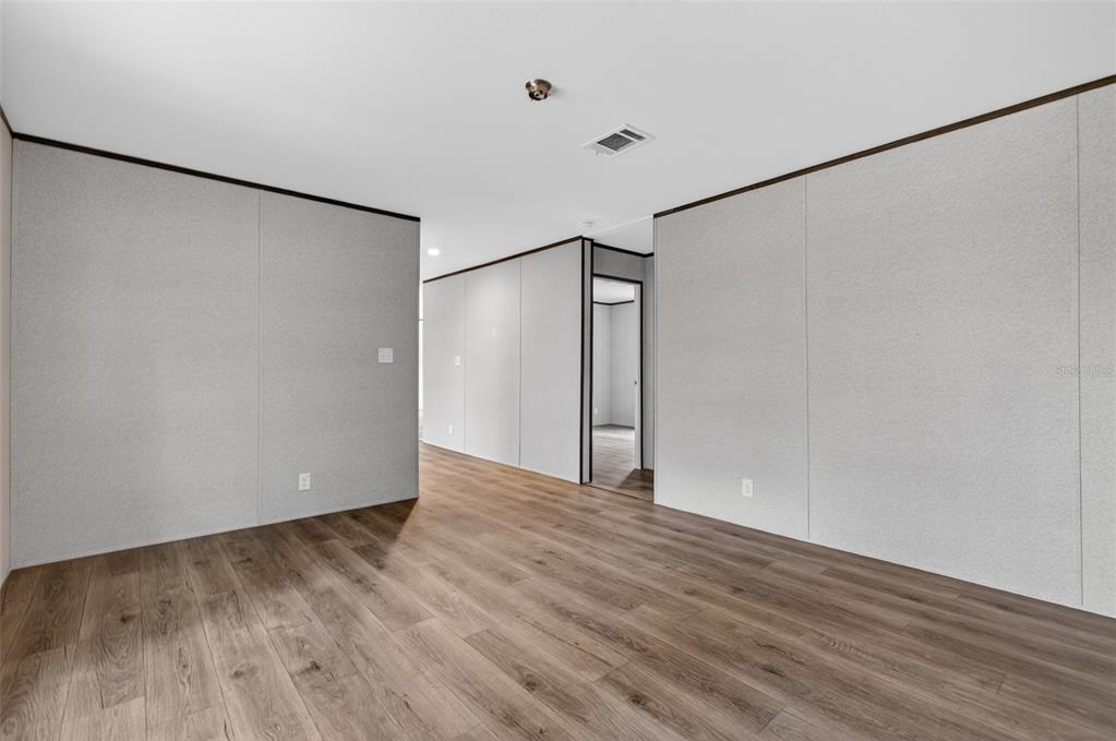 419 Lily Trail Interlachen, FL 32148 - Photo 24 of 82 a view of an empty room with wooden floor