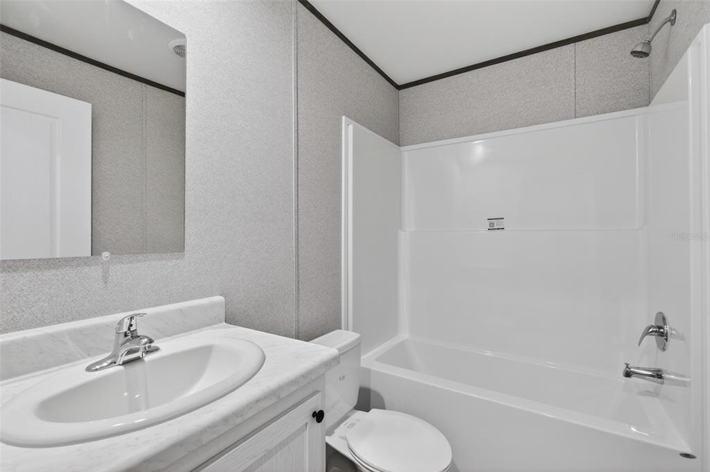 419 Lily Trail Interlachen, FL 32148 - Photo 29 of 82 a bathroom with a sink toilet and bathtub