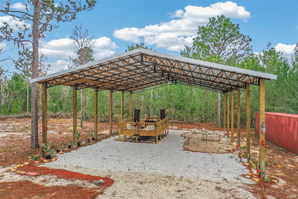 419 Lily Trail Interlachen, FL 32148 - Photo 55 of 78 a backyard of a house with a garden table and chairs