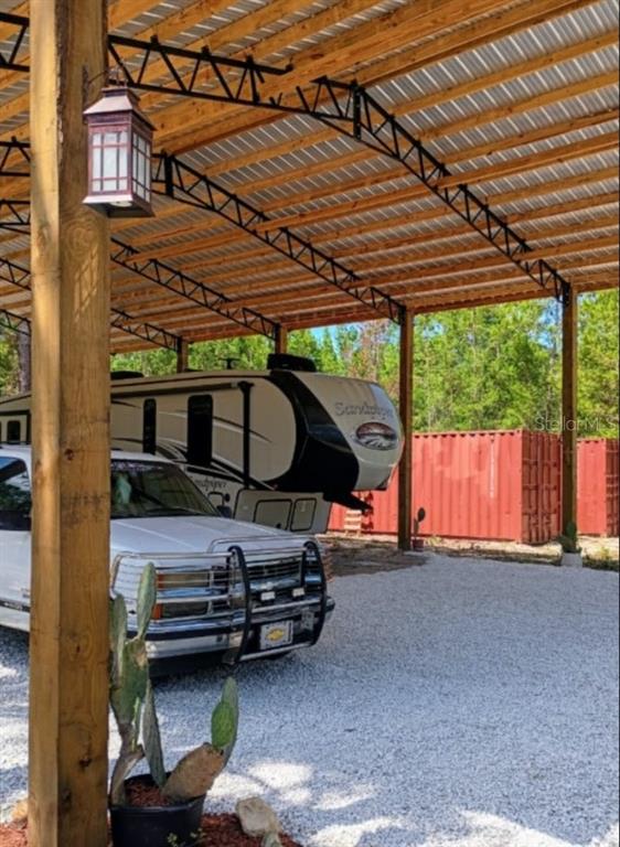 419 Lily Trail Interlachen, FL 32148 - Photo 79 of 82 a view of a patio with table and chairs under an umbrella with a small yard