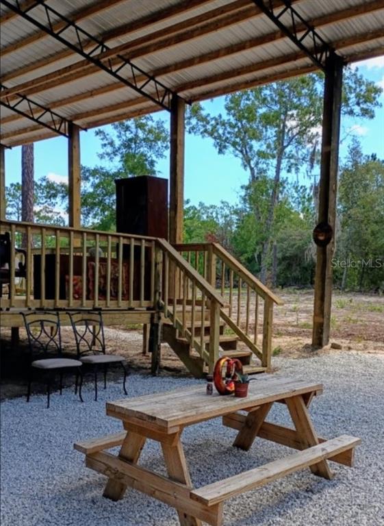419 Lily Trail Interlachen, FL 32148 - Photo 81 of 82 a view of a chair and tables in the deck