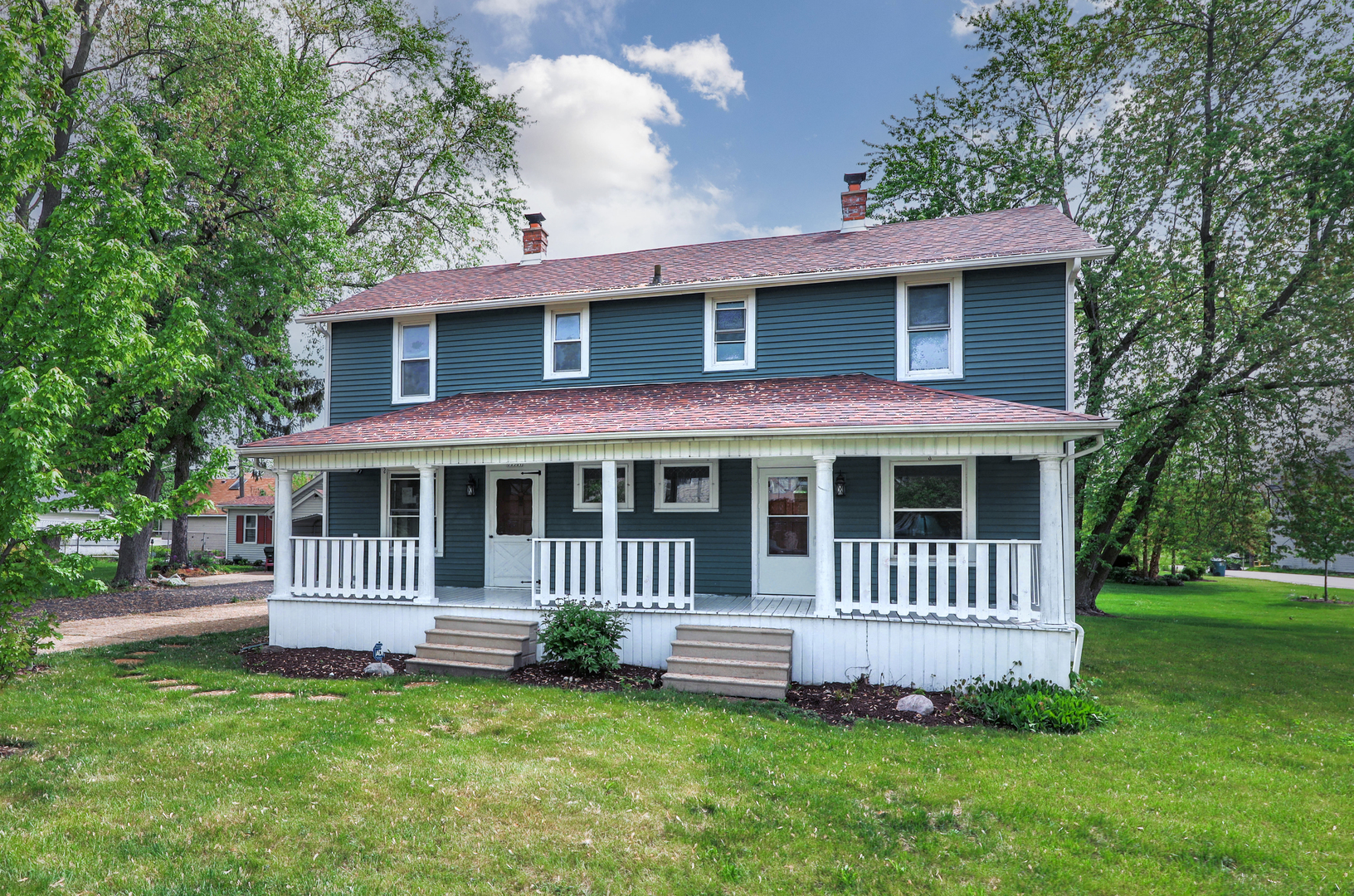 a front view of a house with a garden