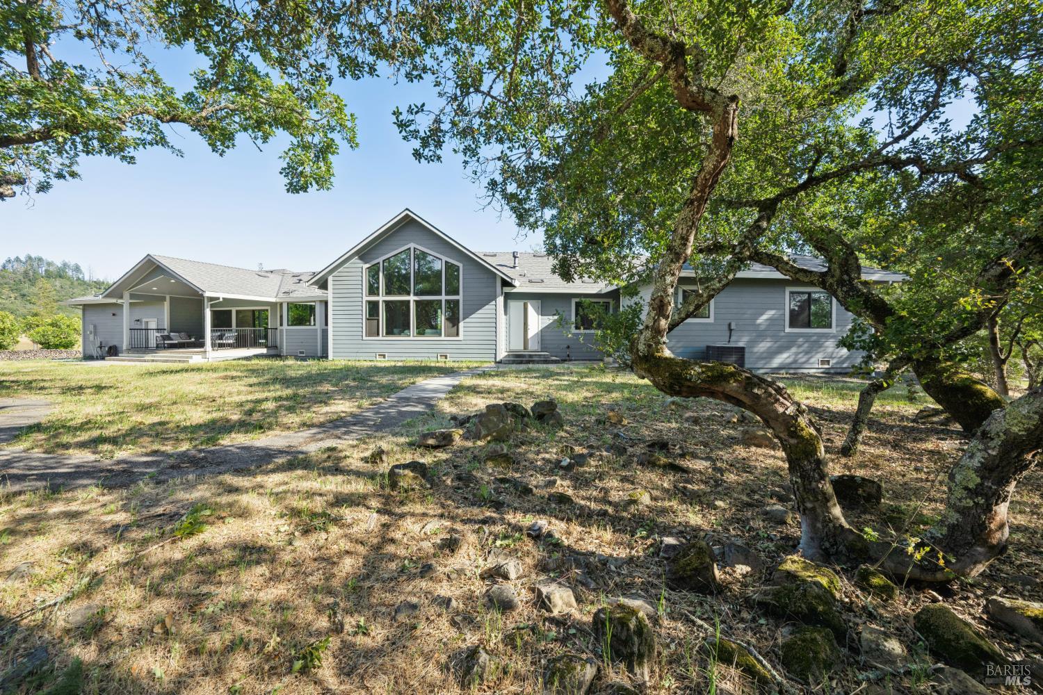 4665 Upper Ridge Road Santa Rosa, CA 95404 - Photo 41 of 71 a front view of a house with a garden and trees