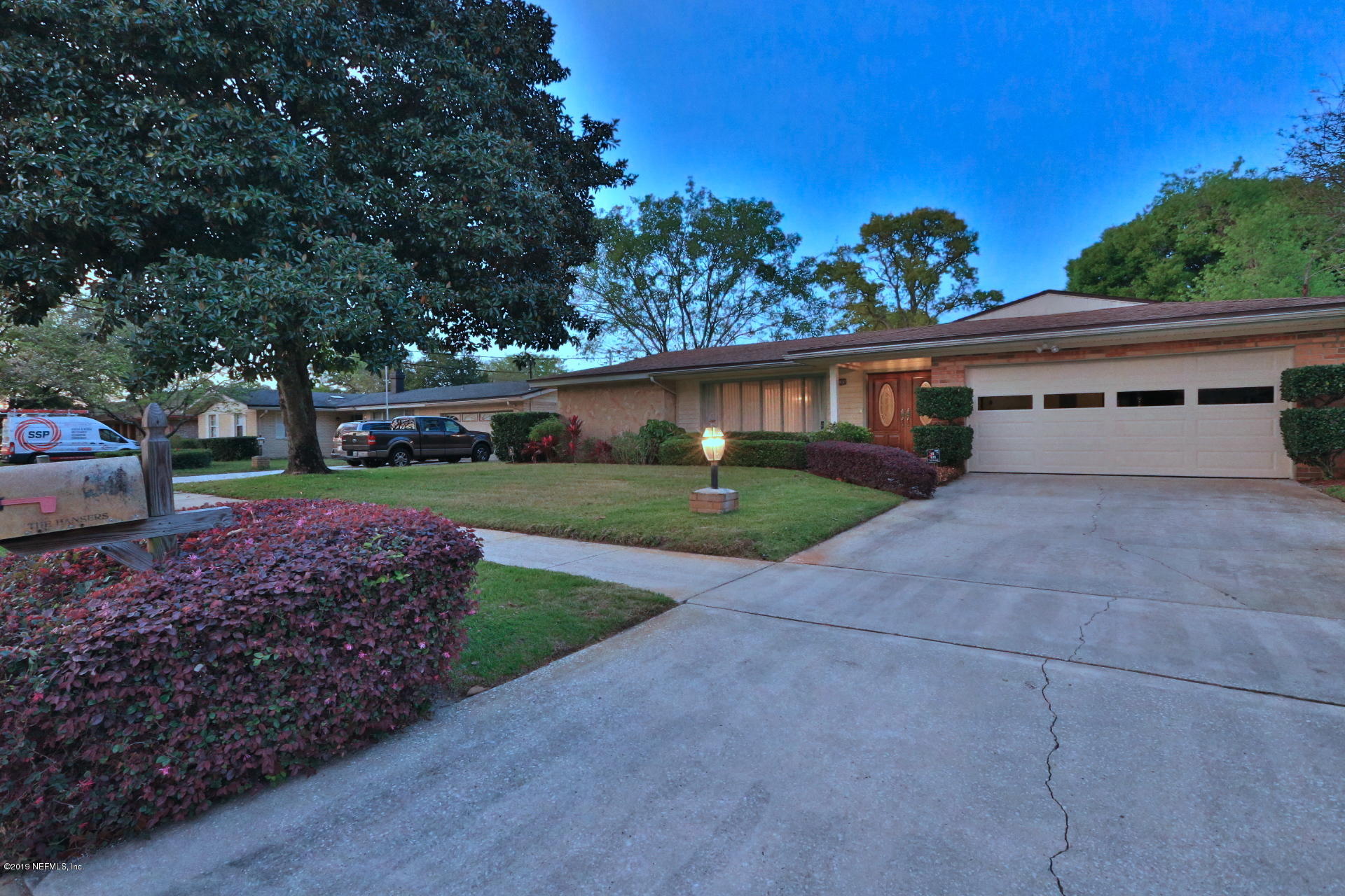 a view of house with outdoor space and garden