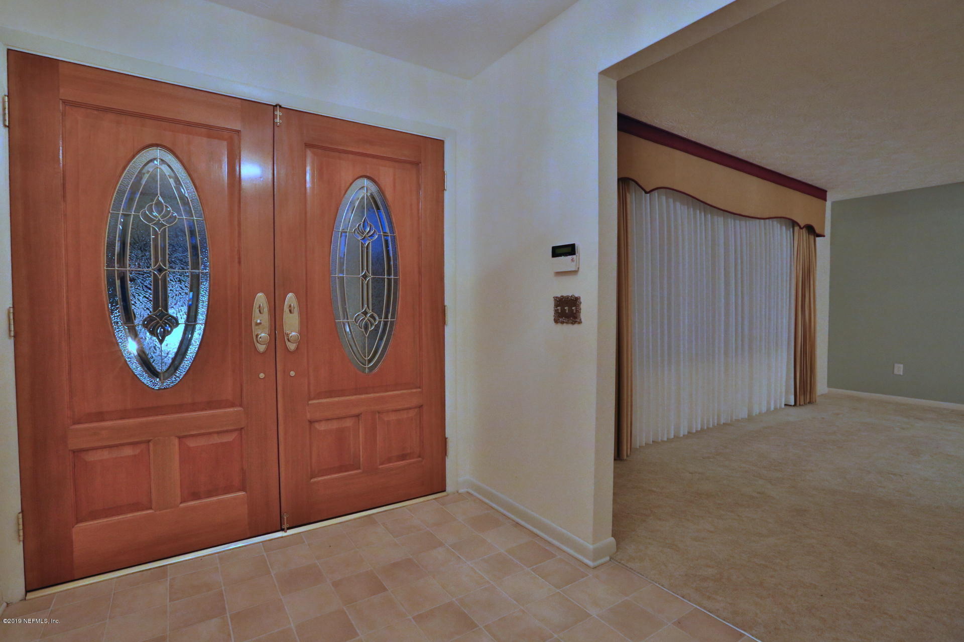 7305 Floral Ridge Drive Jacksonville, FL 32277 - Photo 13 of 27 a view of an entryway with a mirror