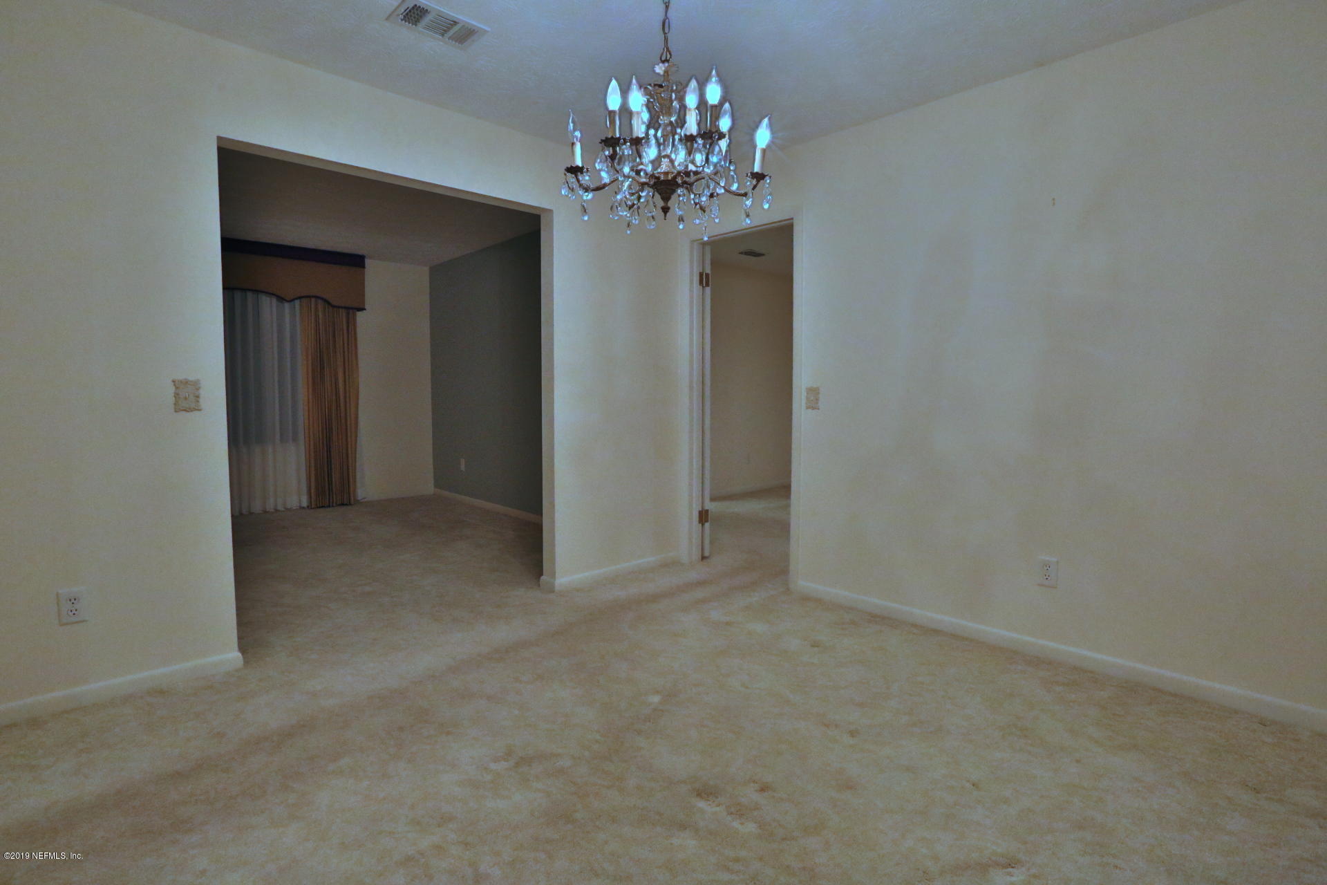 7305 Floral Ridge Drive Jacksonville, FL 32277 - Photo 15 of 27 a view of a chandelier in a room and a chandelier