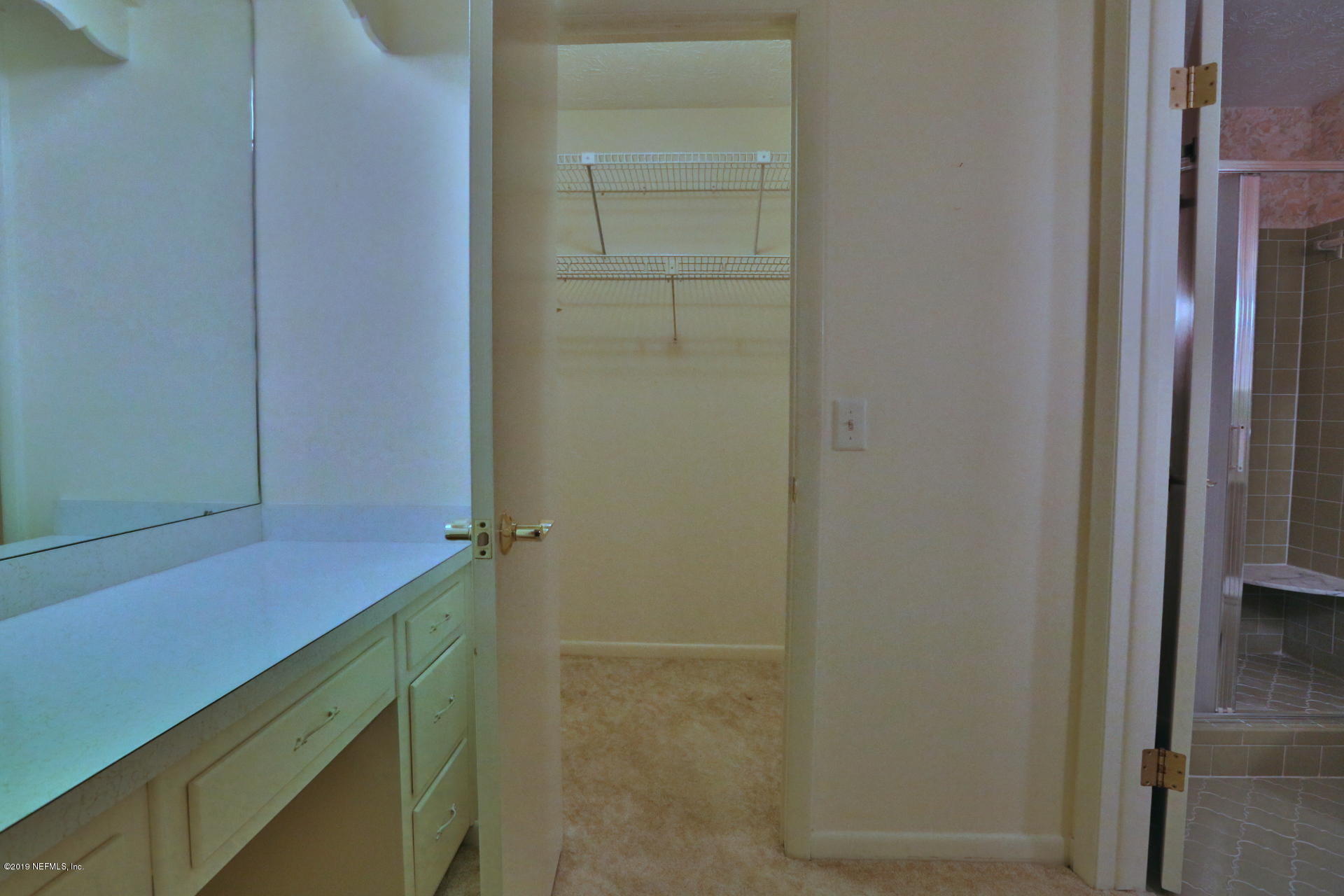 7305 Floral Ridge Drive Jacksonville, FL 32277 - Photo 17 of 27 a bathroom with a shower and a sink