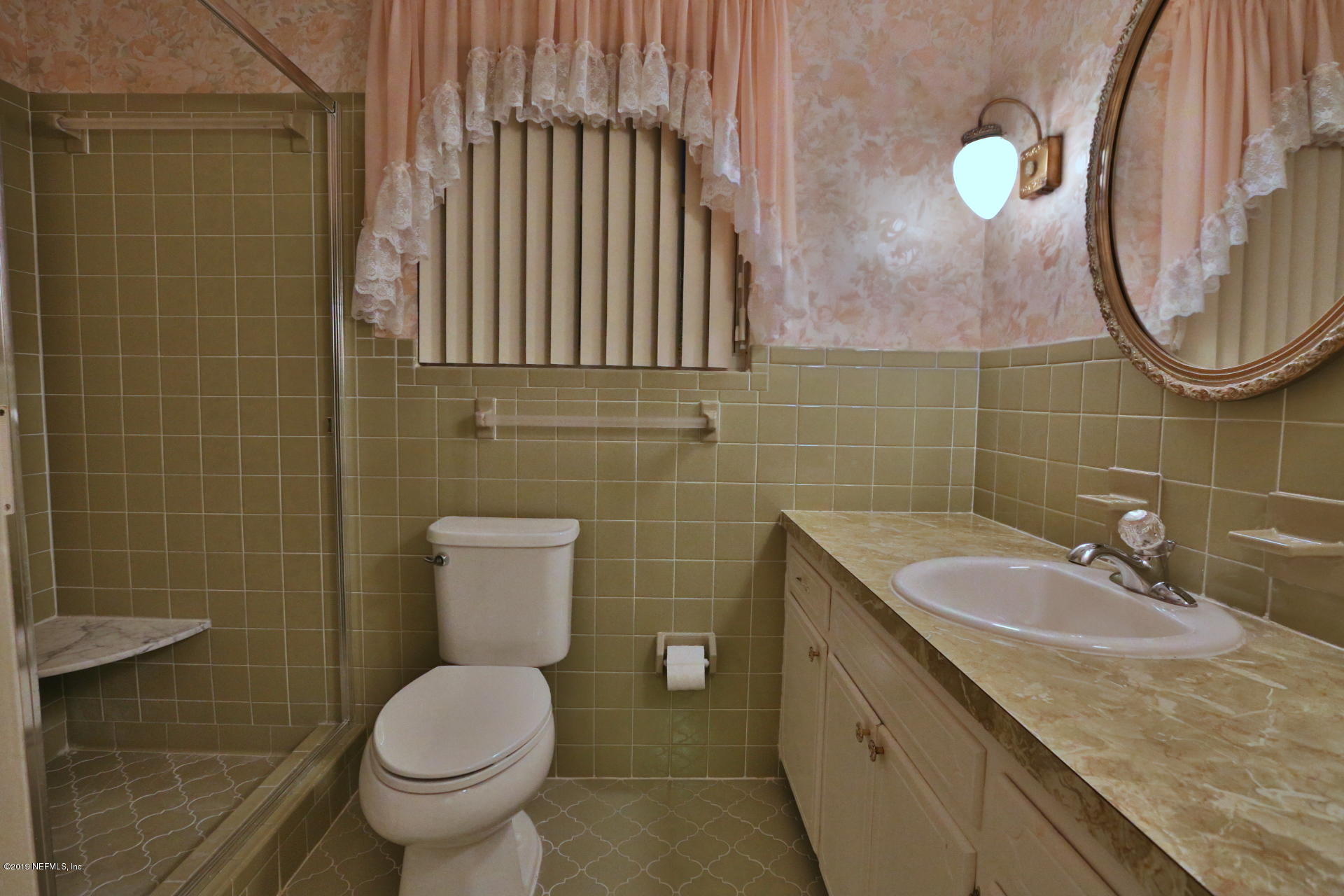 7305 Floral Ridge Drive Jacksonville, FL 32277 - Photo 18 of 27 a bathroom with a granite countertop toilet sink and mirror
