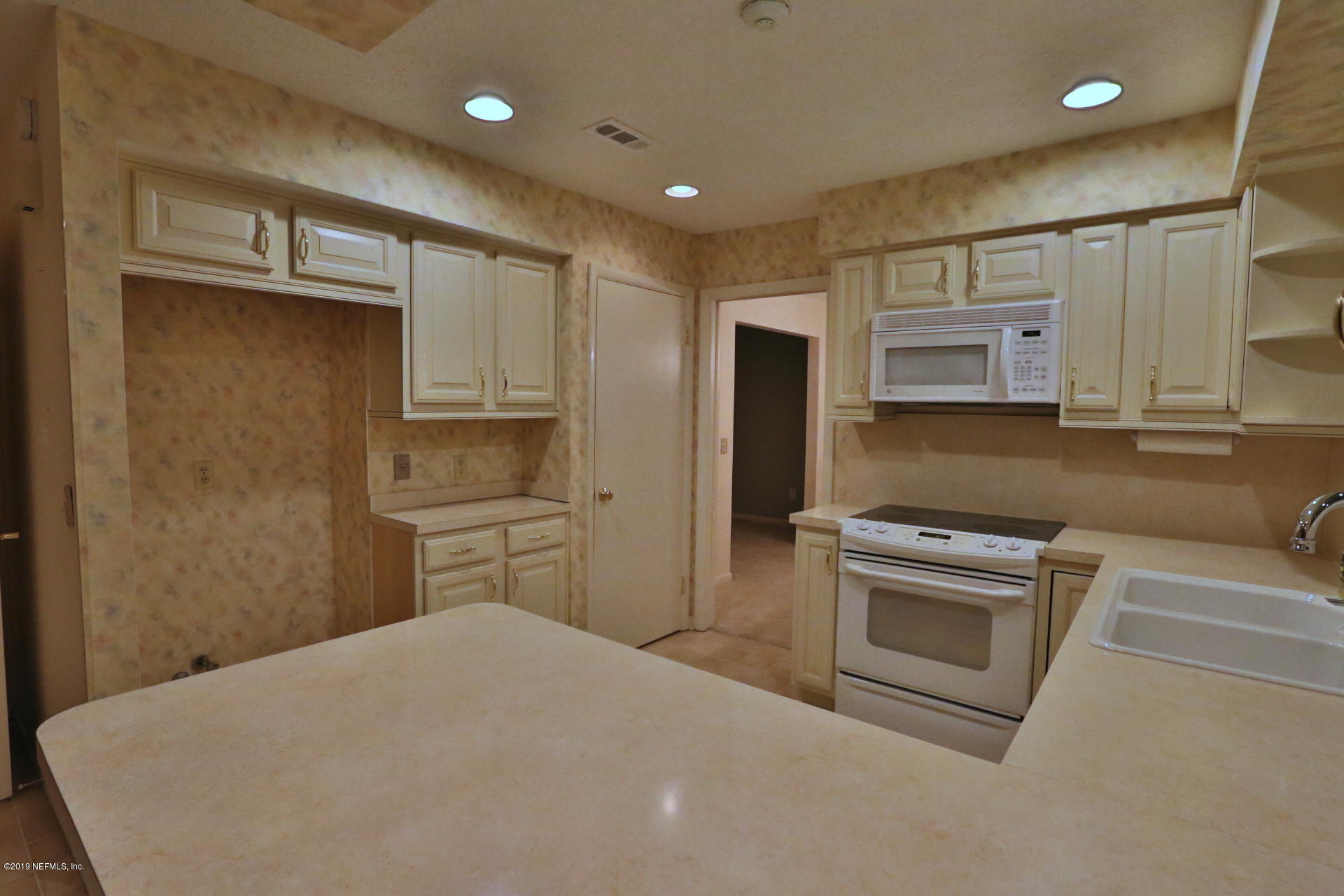 7305 Floral Ridge Drive Jacksonville, FL 32277 - Photo 20 of 27 a kitchen with a refrigerator stove and sink