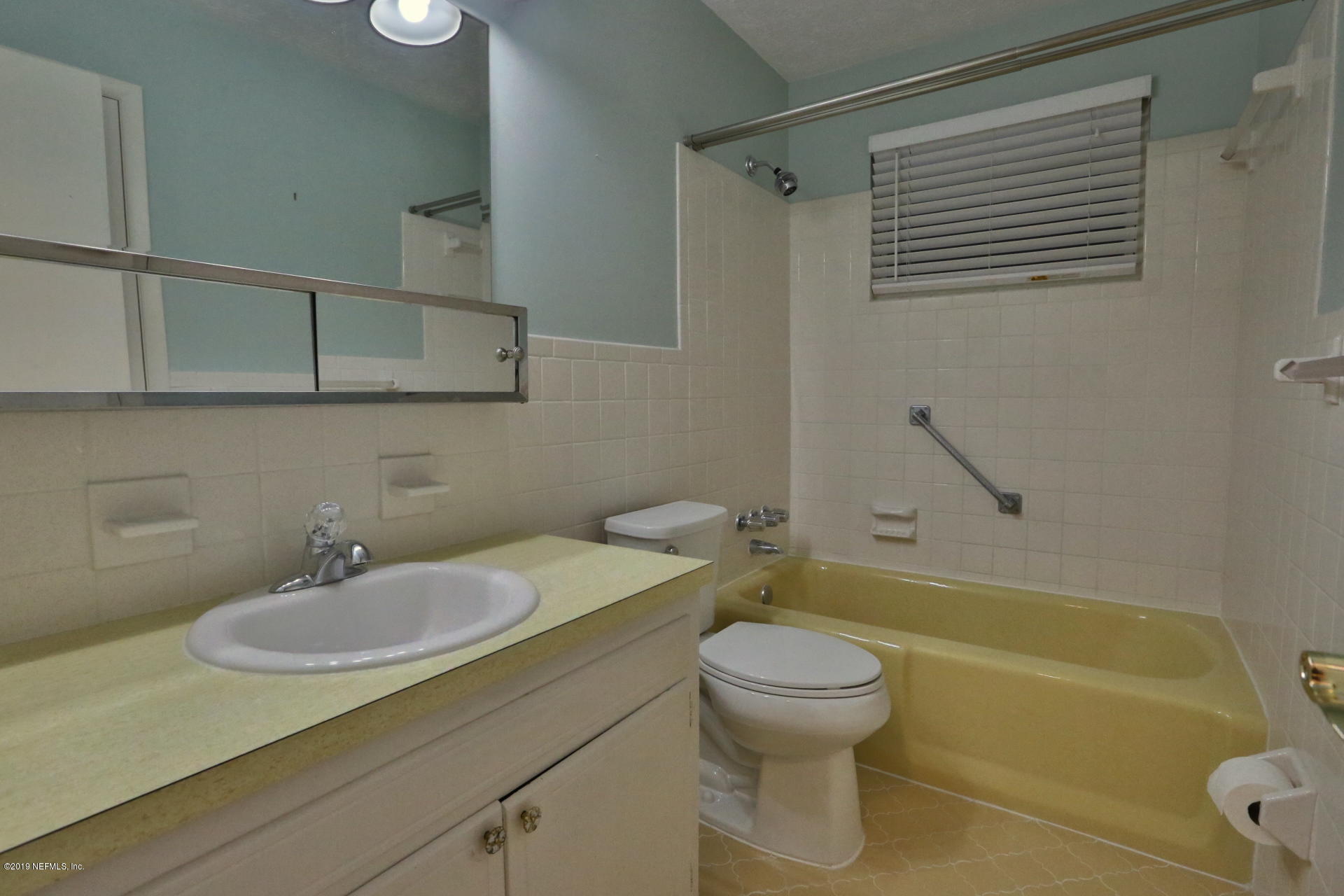 7305 Floral Ridge Drive Jacksonville, FL 32277 - Photo 22 of 27 a bathroom with a sink a toilet and bathtub