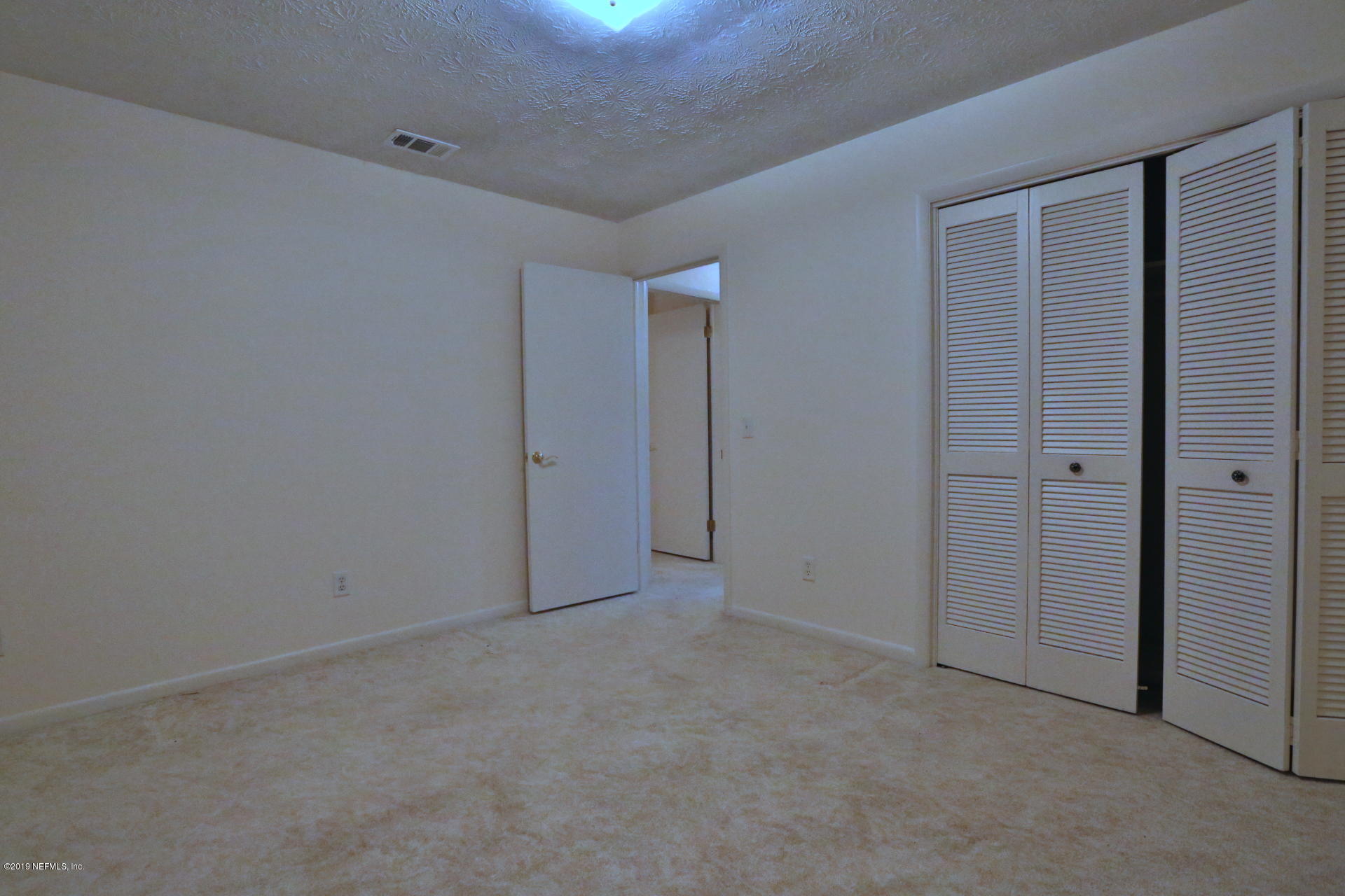 7305 Floral Ridge Drive Jacksonville, FL 32277 - Photo 23 of 27 an empty room with closet area
