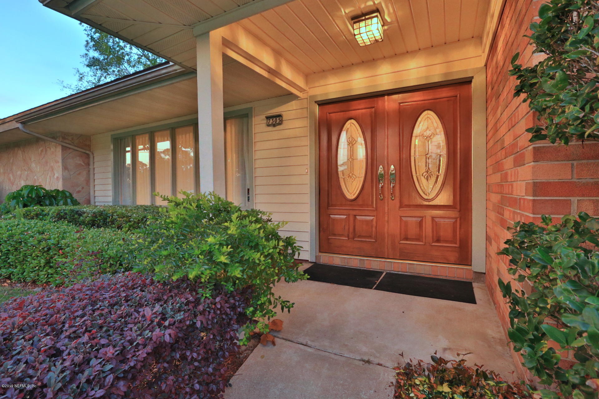 7305 Floral Ridge Drive Jacksonville, FL 32277 - Photo 5 of 27 a couple of potted plants in front of door
