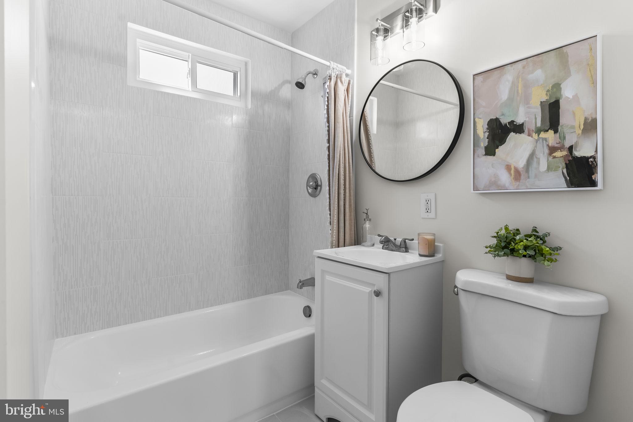 1923 Ridgeville Road Edgewater, MD 21037 - Photo 7 of 15 a bathroom with a toilet a sink and mirror
