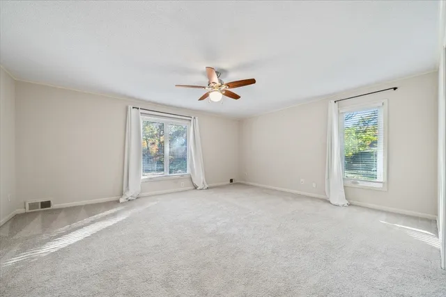 a bathroom with a granite countertop sink a toilet and shower