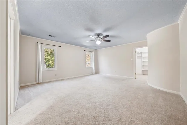 a spacious bathroom with a granite countertop sink mirror and shower