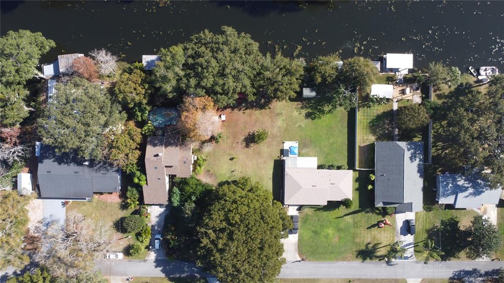 an aerial view of a house with a yard basket ball court and outdoor seating