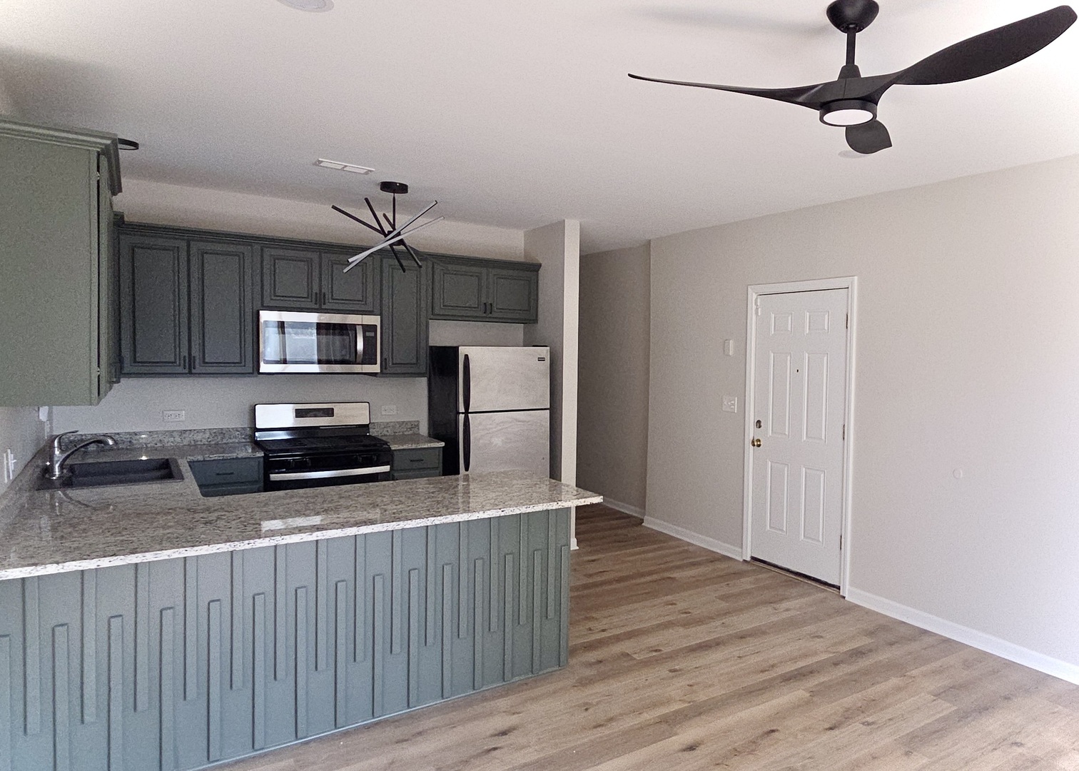 6439 South St Lawrence Avenue, Unit 2 Chicago, IL 60637 - Photo 2 of 8 a kitchen with stainless steel appliances a refrigerator and a stove top oven