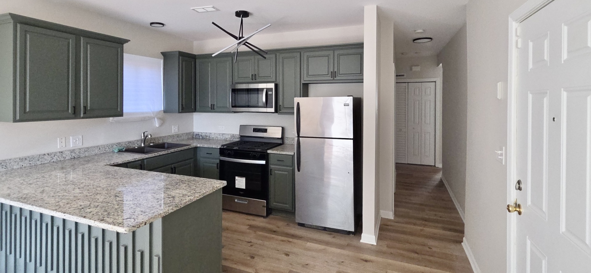 6439 South St Lawrence Avenue, Unit 2 Chicago, IL 60637 - Photo 3 of 8 a kitchen with kitchen island a counter top space stainless steel appliances and cabinets