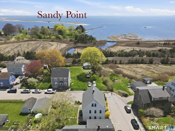 an aerial view of a house with garden space and lake view