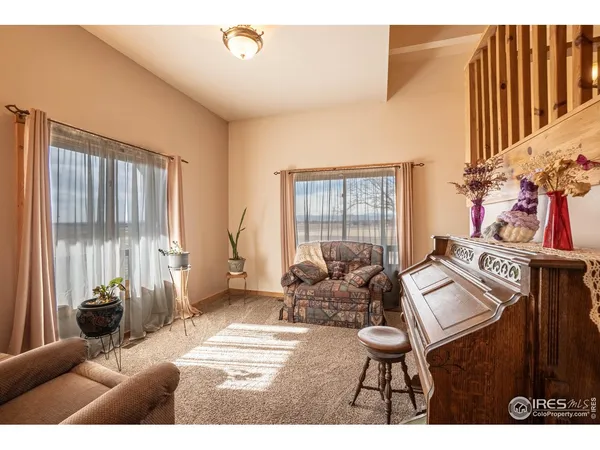 a living room with furniture and a floor to ceiling window
