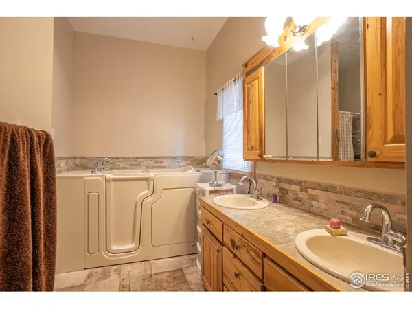 a bathroom with a sink vanity and a mirror