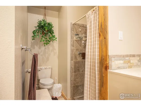 a bathroom with a toilet a sink and shower