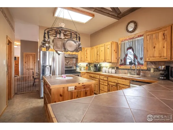 a kitchen with stainless steel appliances kitchen island granite countertop a sink and cabinets