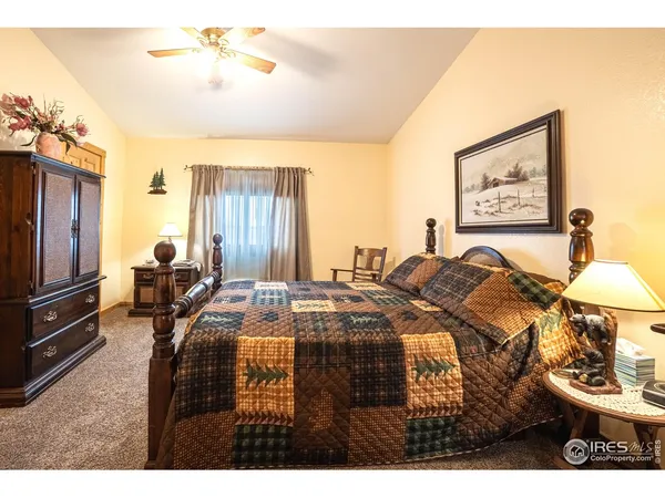 a bed room with a bed and a chair