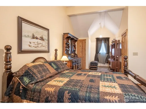 a bedroom with a bed a lamp and a large mirror