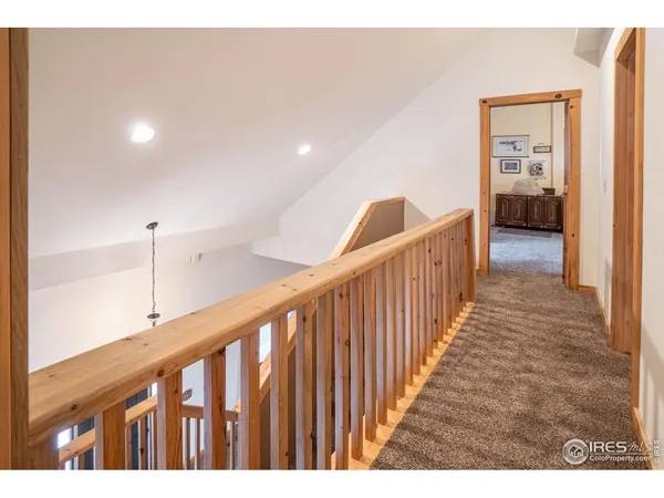 a view of hallway with wooden floor