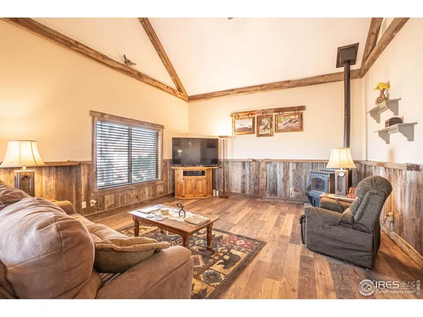 a bedroom with furniture and a large window