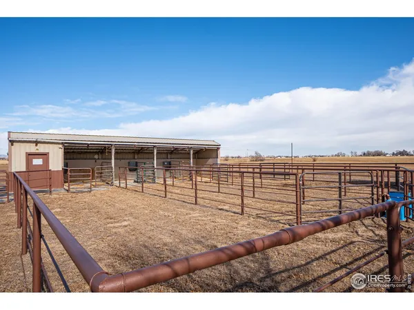 a view of a roof deck with dining table and chairs