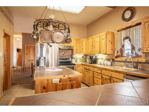 a kitchen with stainless steel appliances granite countertop a sink and cabinets