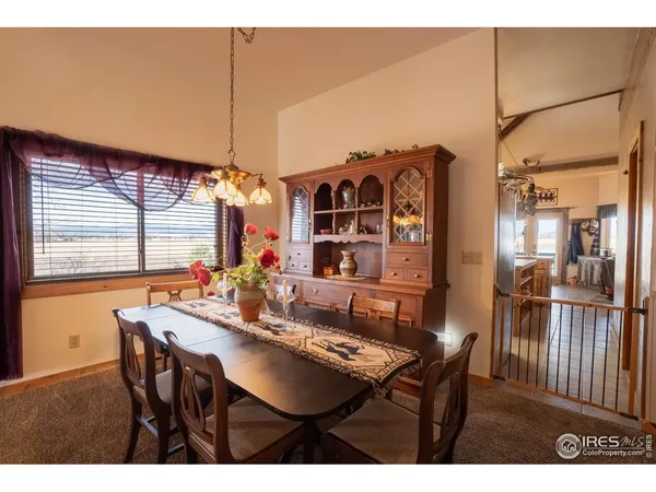 a view of a dining room with furniture and window