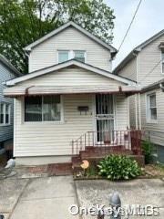 a view of a white house with large windows