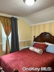 164-54 Nadal Place Queens, NY 11433 - Photo 7 of 9 a bedroom with a bed and a dresser