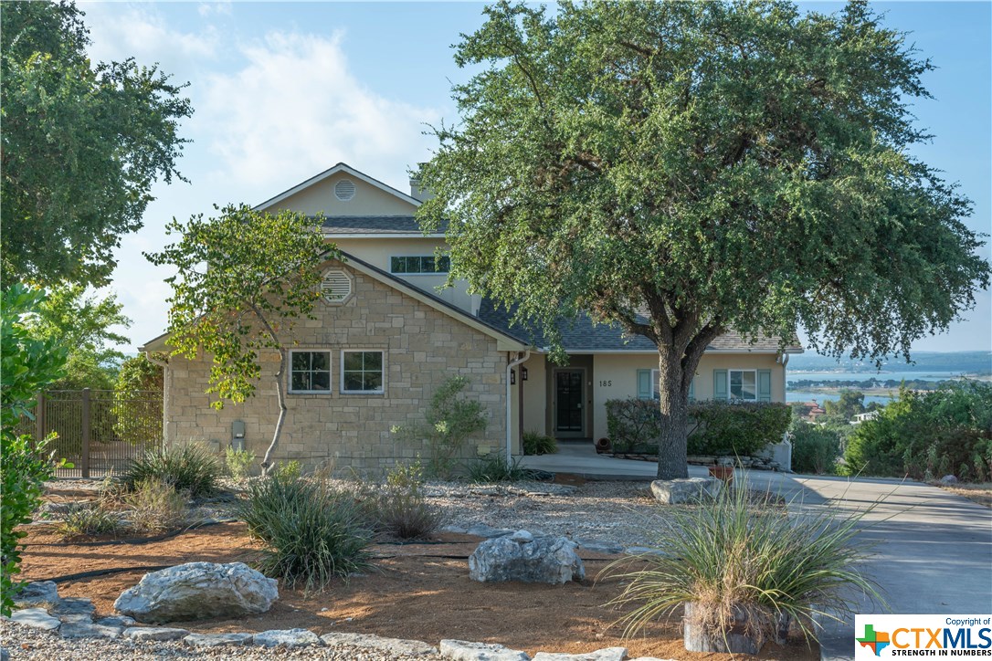 a backyard of a house with plants and trees
