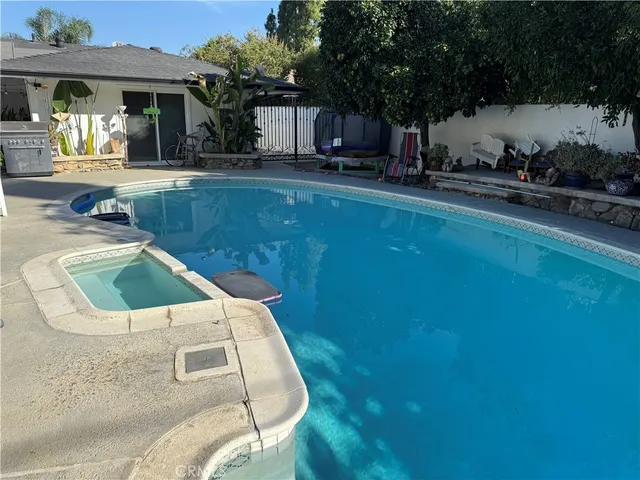 a view of a swimming pool with an outdoor seating