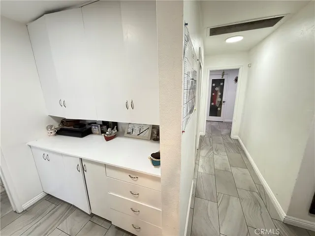 a white toilet sitting next to a small window