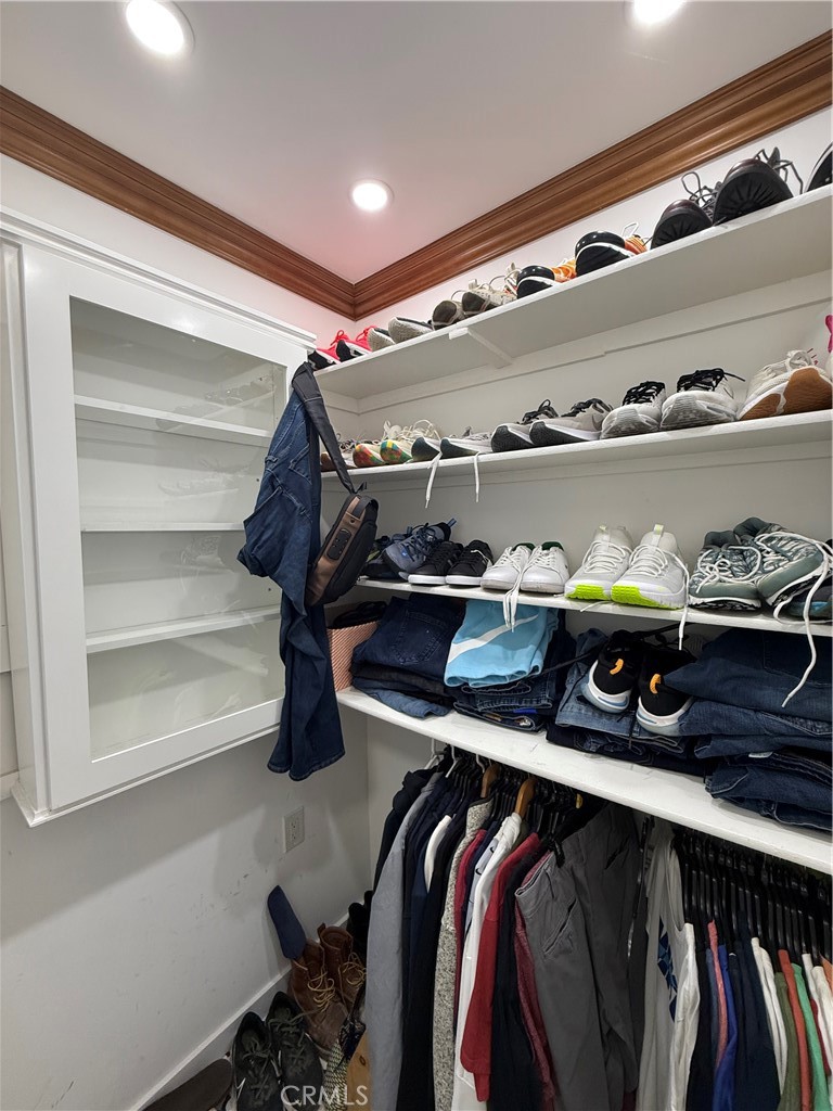 5836 Old Ranch Road Riverside, CA 92504 - Photo 28 of 59 a view of walk in closet with clothes and shoes