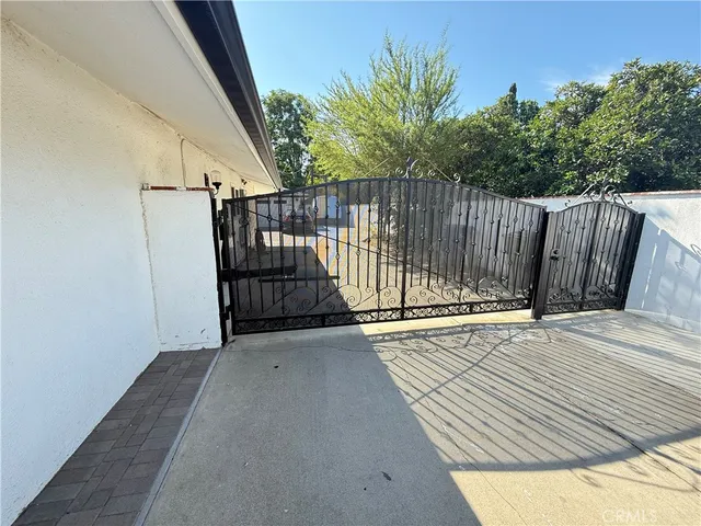 a view of a balcony with wooden floor and fence