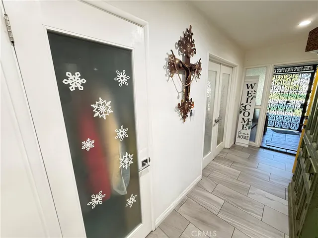 a view of a kitchen with kitchen island a stove a sink a refrigerator and a dining table