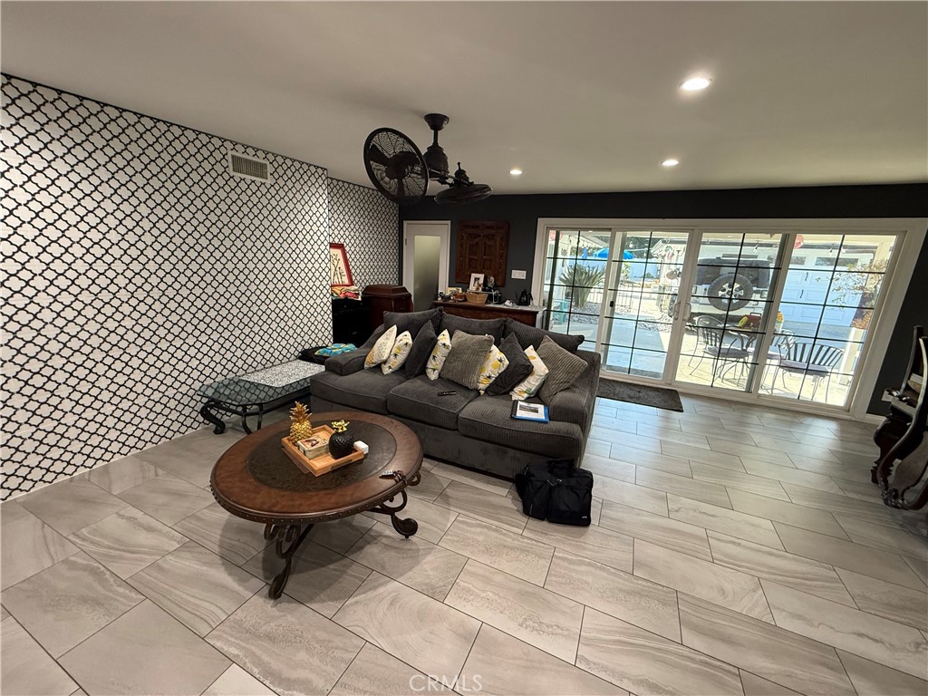 5836 Old Ranch Road Riverside, CA 92504 - Photo 39 of 59 a living room with furniture and a floor to ceiling window