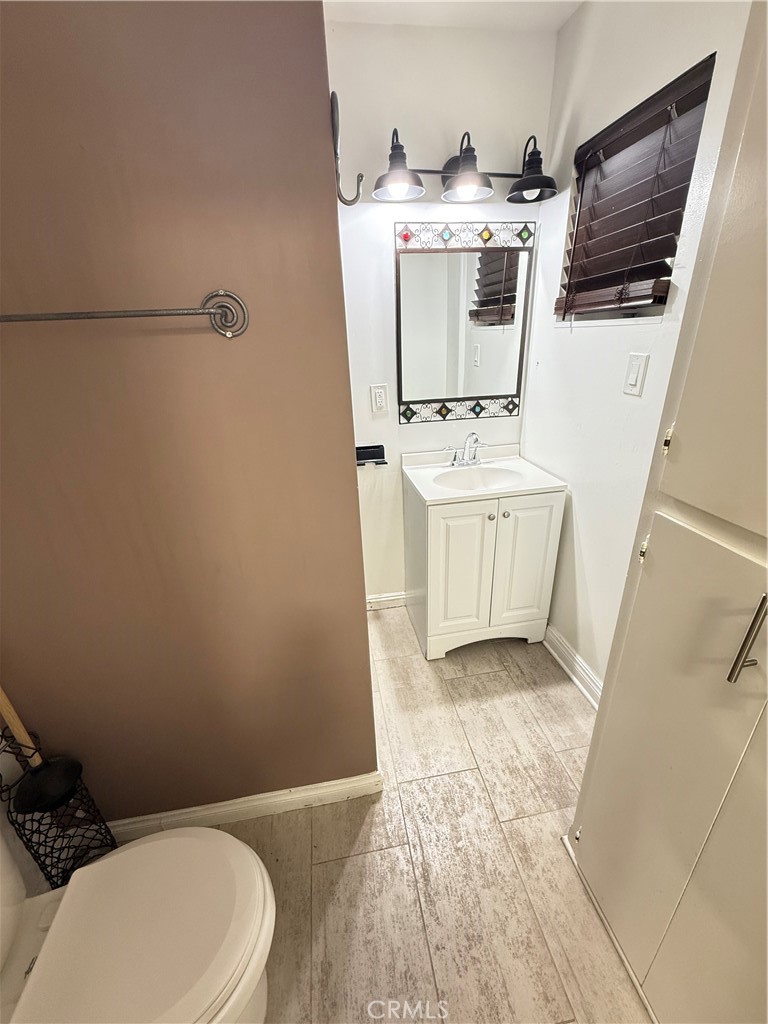 5836 Old Ranch Road Riverside, CA 92504 - Photo 57 of 59 a bathroom with a sink a toilet and mirror