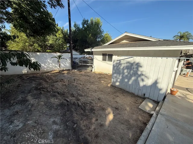 a view of a house with swimming pool and sitting area
