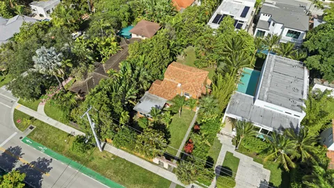 an aerial view of a house with a yard and garden