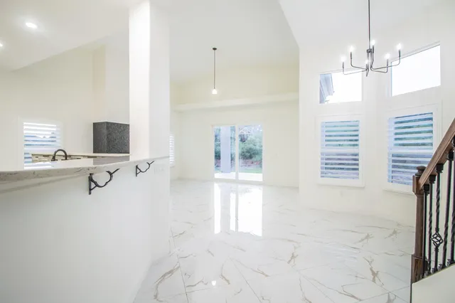 a view of a kitchen with a refrigerator and a window