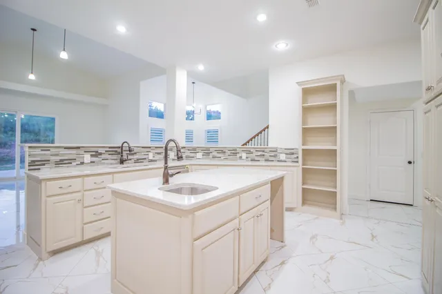 a view of a kitchen with wooden floor and cabinets