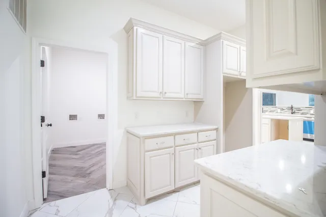 an empty room with fan and windows